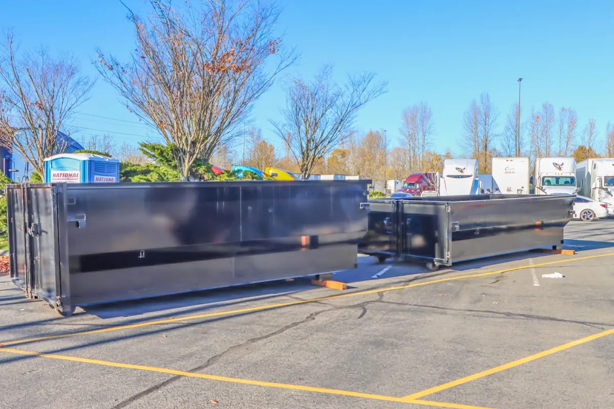 Professional dumpster rental service with roll-off container on residential driveway in Hutchins